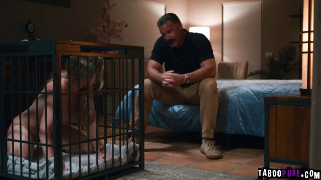 Charles Dera and Cory Chase engage in cage play with Nina White