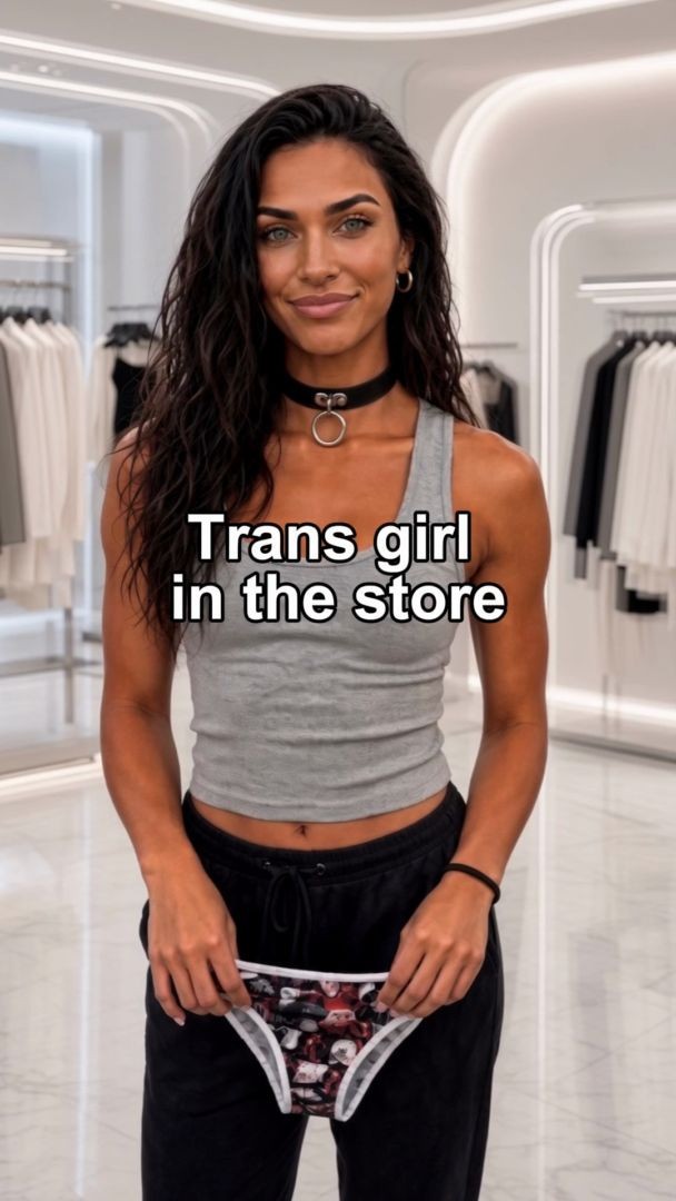 Transgirl in White Shirt Poses by City Window