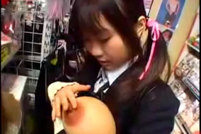 Provoking Japanese schoolgirl with pigtails displays her pussy